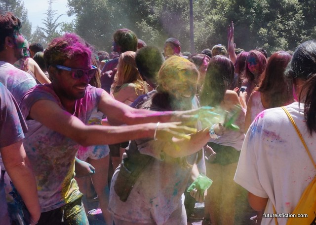 A stranger and I toss color onto another stranger at Holi