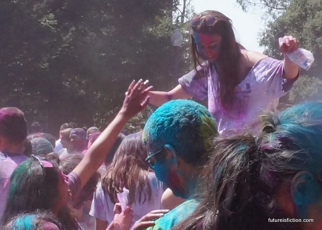 Two people touch hands at UC Berkeley's Holi fest