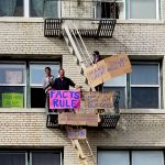 Dudes on fire escape with signs: FACTS RULE, and "Make Signs Great Again"