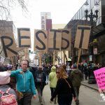 Protestors at Oakland Women's March carrying letters that collectively spelll RESIST