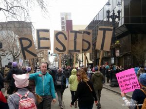 Protestors at Oakland Women's March carrying letters that collectively spelll RESIST