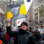 Protestor at Oakland Woman's march whose sign is a painting of a woman and the ltters WE ARE NOT THINGS