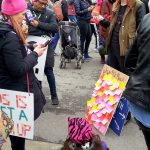 "Why We March" protest sign with post it notes filled out by protestors