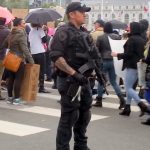 cop with automatic weapon at SF Women's March