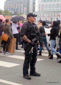 cop with automatic weapon at SF Women's March