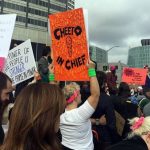 protest sign covered in actual cheetos.