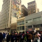 Oakland Women's March protestors with huge mural in background. Downtown Oakland