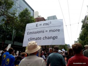 protest sign: E=MC^2/ Emissions = More Climate Change