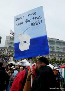 protest sign with a polar bear in a tiny bit of ice: "Don't have time for this shit"